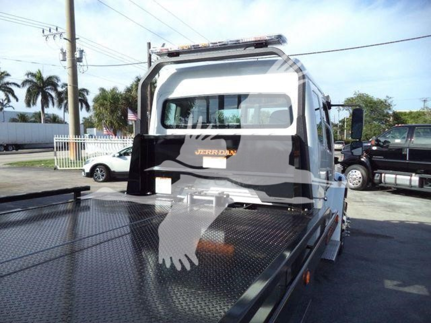 Trailer hitch back of Freightliner M2 106 Plus with Jerr-Dan roll-back body and rear window; stock and vehicle lines not visible in image.