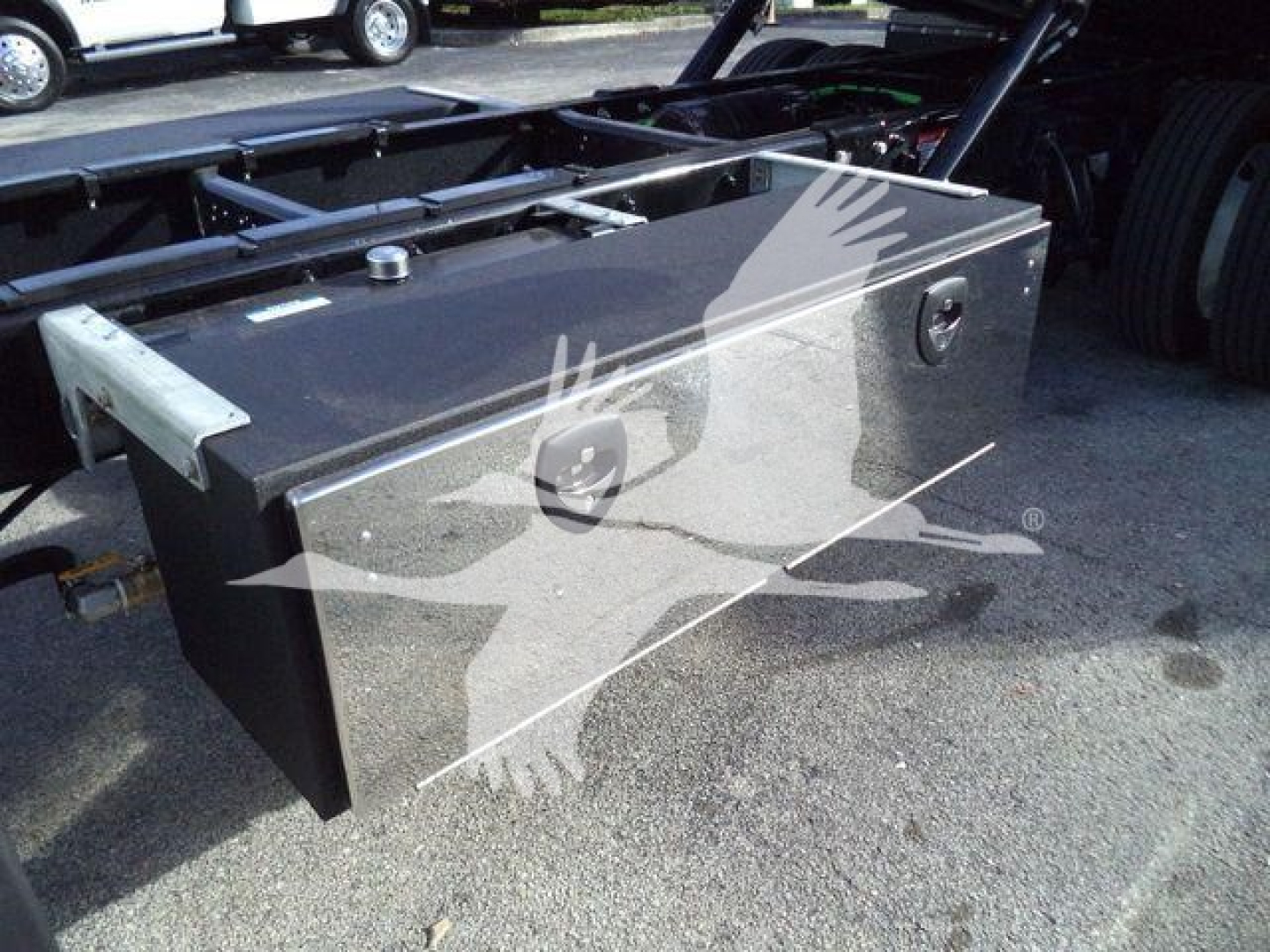 Diamond plated toolbox mounted on a Freightliner M2 chassis showing top surface with latches and access handle.