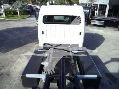 Front cab and chassis of a Freightliner M2 106 Plus rollback truck showing bare chassis, frame rails, and attachment points.