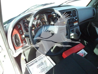 Trucks cab interior of 2027 Freightliner M2 106 Plus showing dashboard with steering wheel, gauges, and center console.
