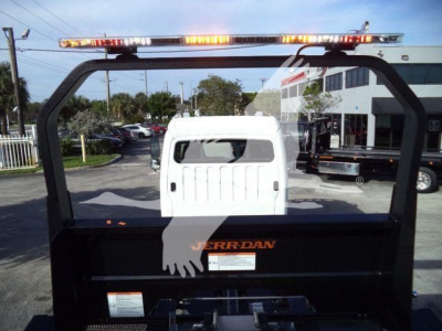 Freightliner M2 106 Plus rollback truck rear view showing cab and roll-over frame with orange Parker lettering and light bar on top.