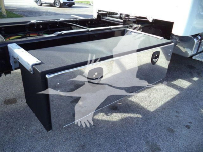 Storage toolbox mounted on a Freightliner M2 106 Plus rollback truck showing a black metal storage box with metal latches.