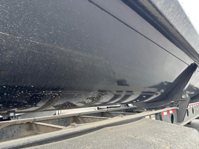 Dump trailer side view showing Jet Air Ride Jet Side Dump component with black painted undercarriage and frame
