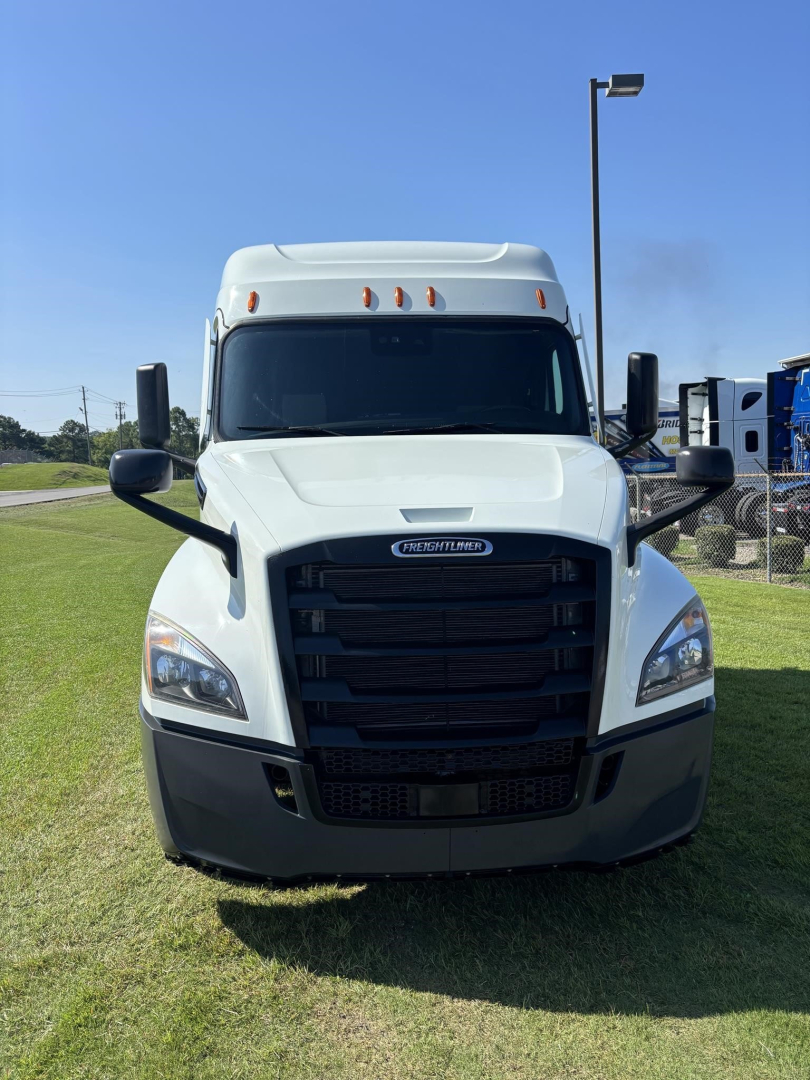 Front view of a white 2021 Freightliner Cascadia 126 truck with black grille, large mirrors, and aerodynamic hood.