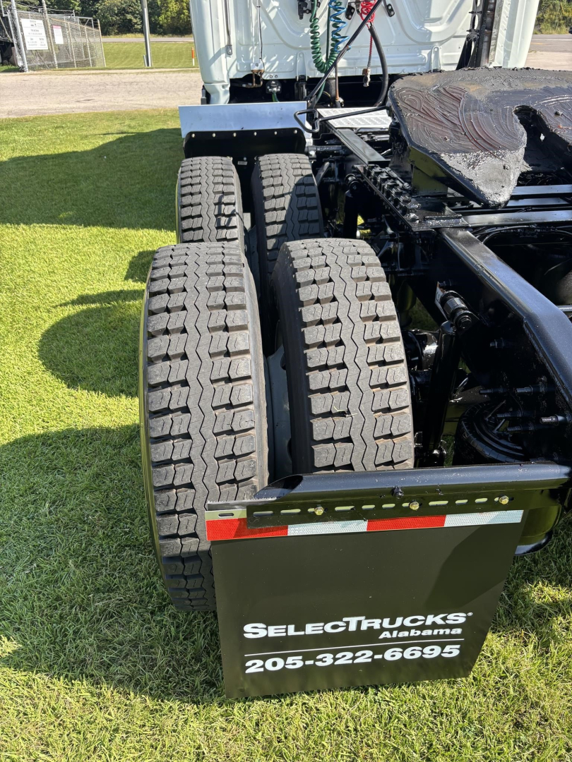 Truck chassis rear view with dual rear axles and tires visible; mudflap shows ‘SELECT TRUCKS Alabama 205-322-6695’