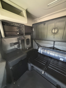 Freightliner Cascadia 126 sleeper cab interior showing storage compartments and bunk area