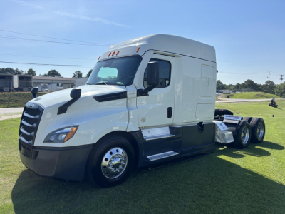 Freightliner Cascadia 126 sleeper cab truck side view showing white exterior, large hood, black bumper, chrome wheels, and fifth wheel chassis.