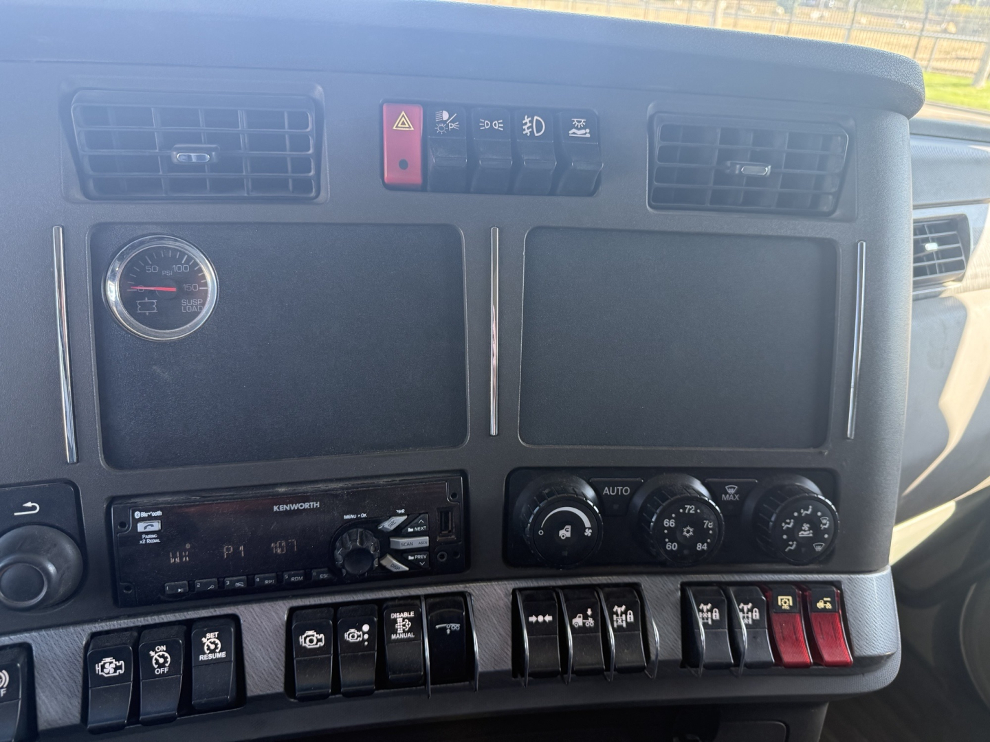 Kenworth T880 dash and instrument cluster with switches and gauges visible in cab interior.