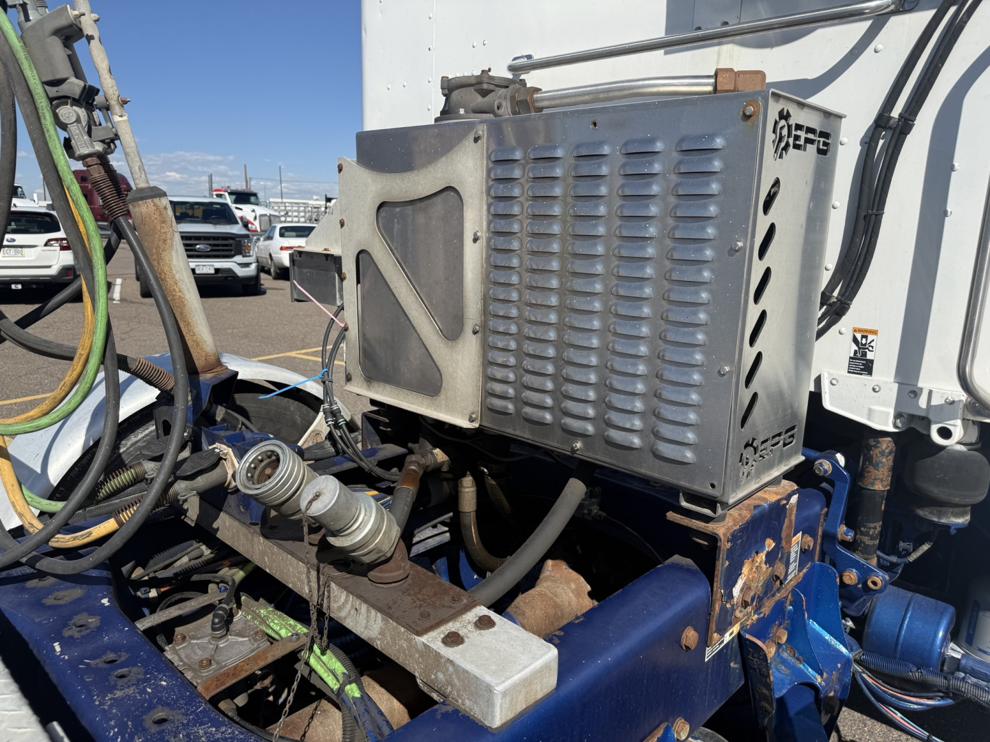 Kenworth T880 engine bay area showing radiator or intercooler assembly and surrounding hoses and frame