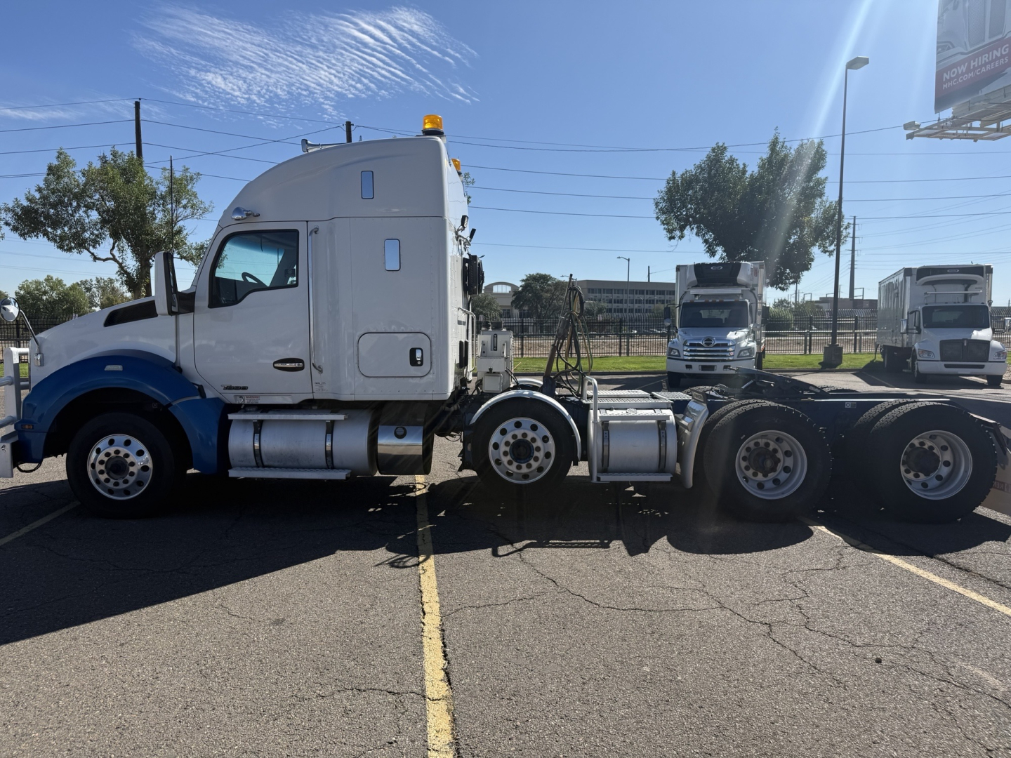 Kenworth T880 truck cab and chassis side view showing sleeper cab and dual rear axles.