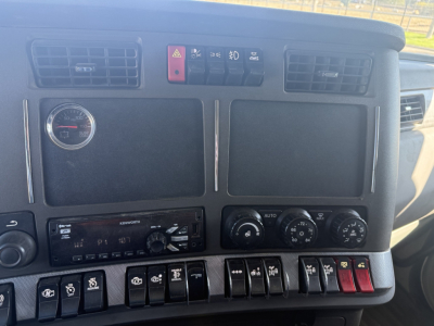 Kenworth T880 dash and instrument cluster with switches and gauges visible in cab interior.