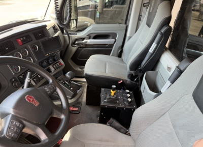 Kenworth T880 truck interior showing driver seat and center console with control levers and dashboard text