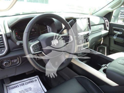 Ram truck interior showing steering wheel, dash, and center console with large touchscreen display.