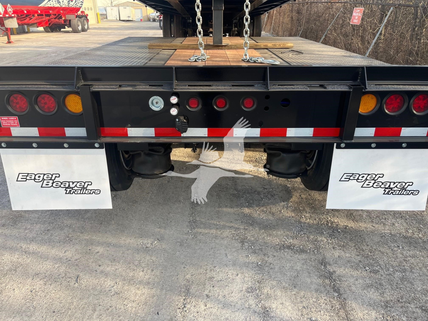 Eager Beaver 50Gsl-Pt lowboy trailer rear view showing taillights, mud flaps labeled Eager Beaver Trailers, and deck hooks.