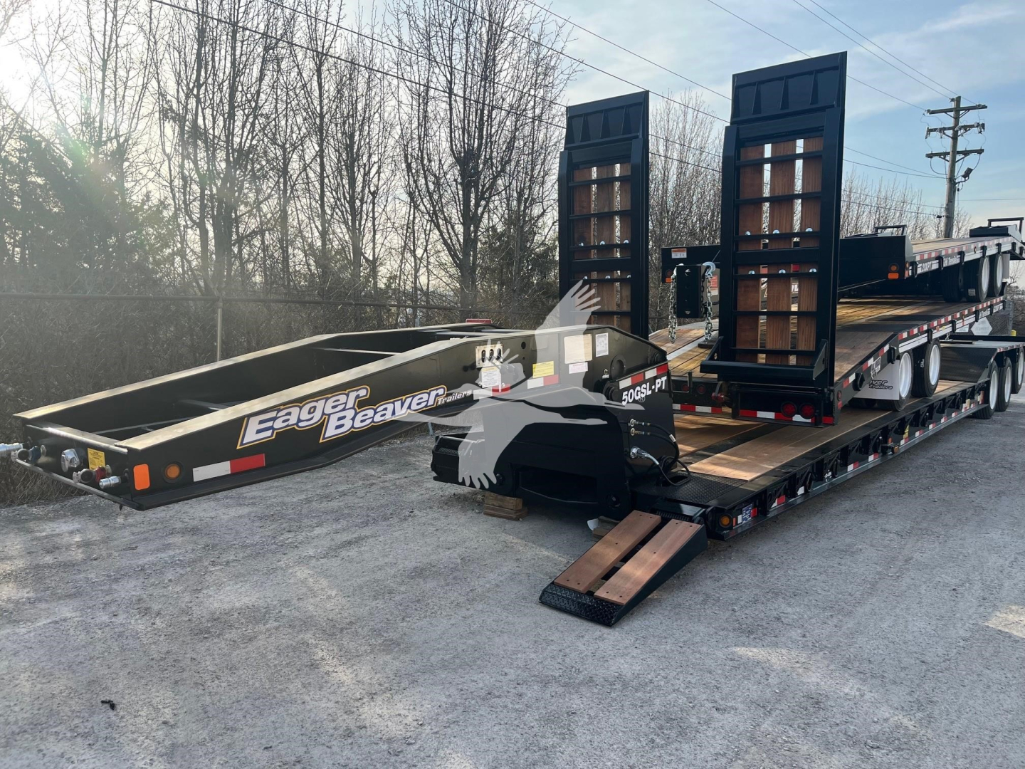 Eager Beaver 50Gsl-Pt lowboy trailer on ramp with loading equipment and black frame, side logo reading Eager Beaver.