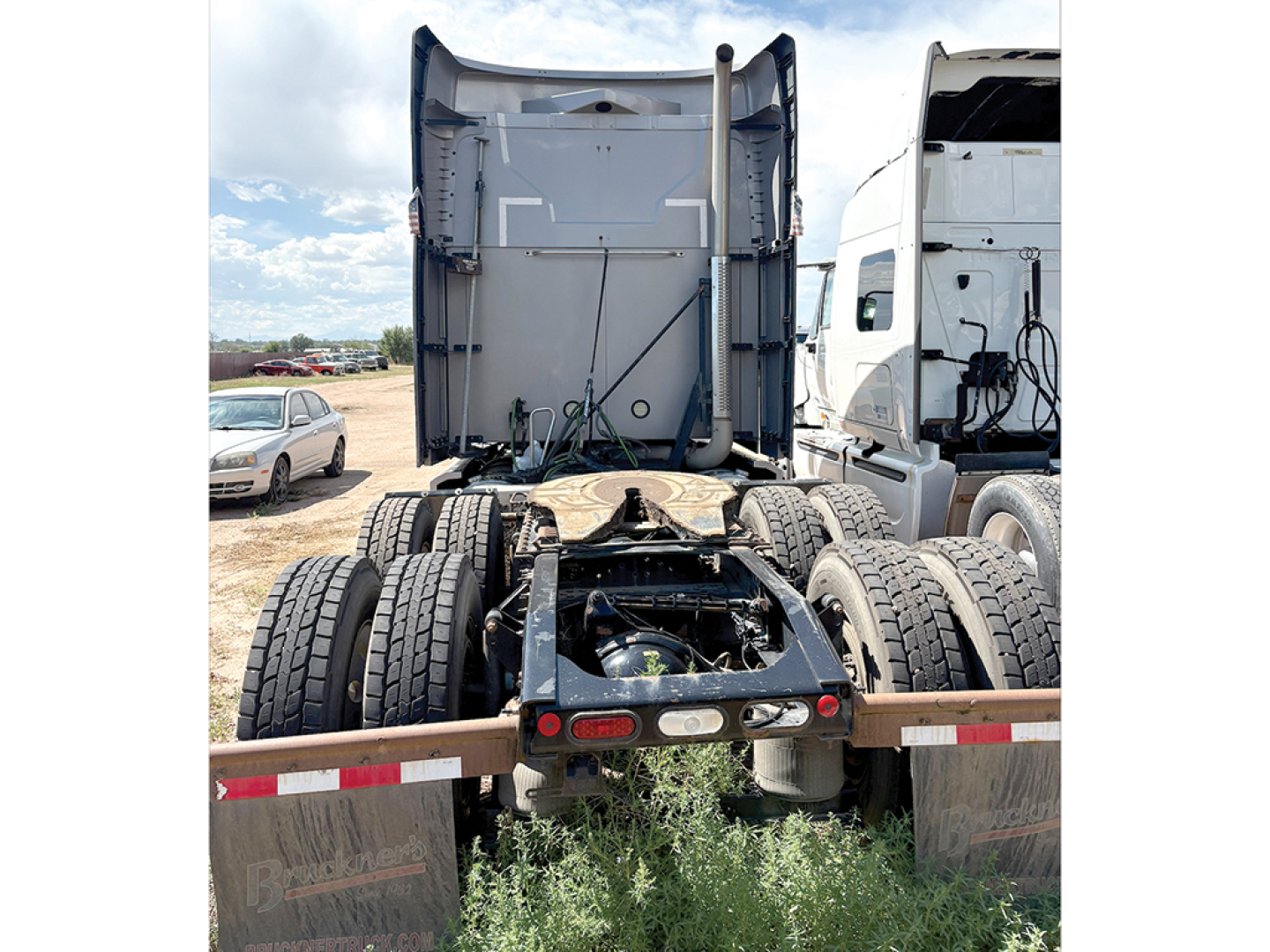 Truck rear view showing fifth wheel and dual rear axles of a Mack Anthem sleeper tractor.