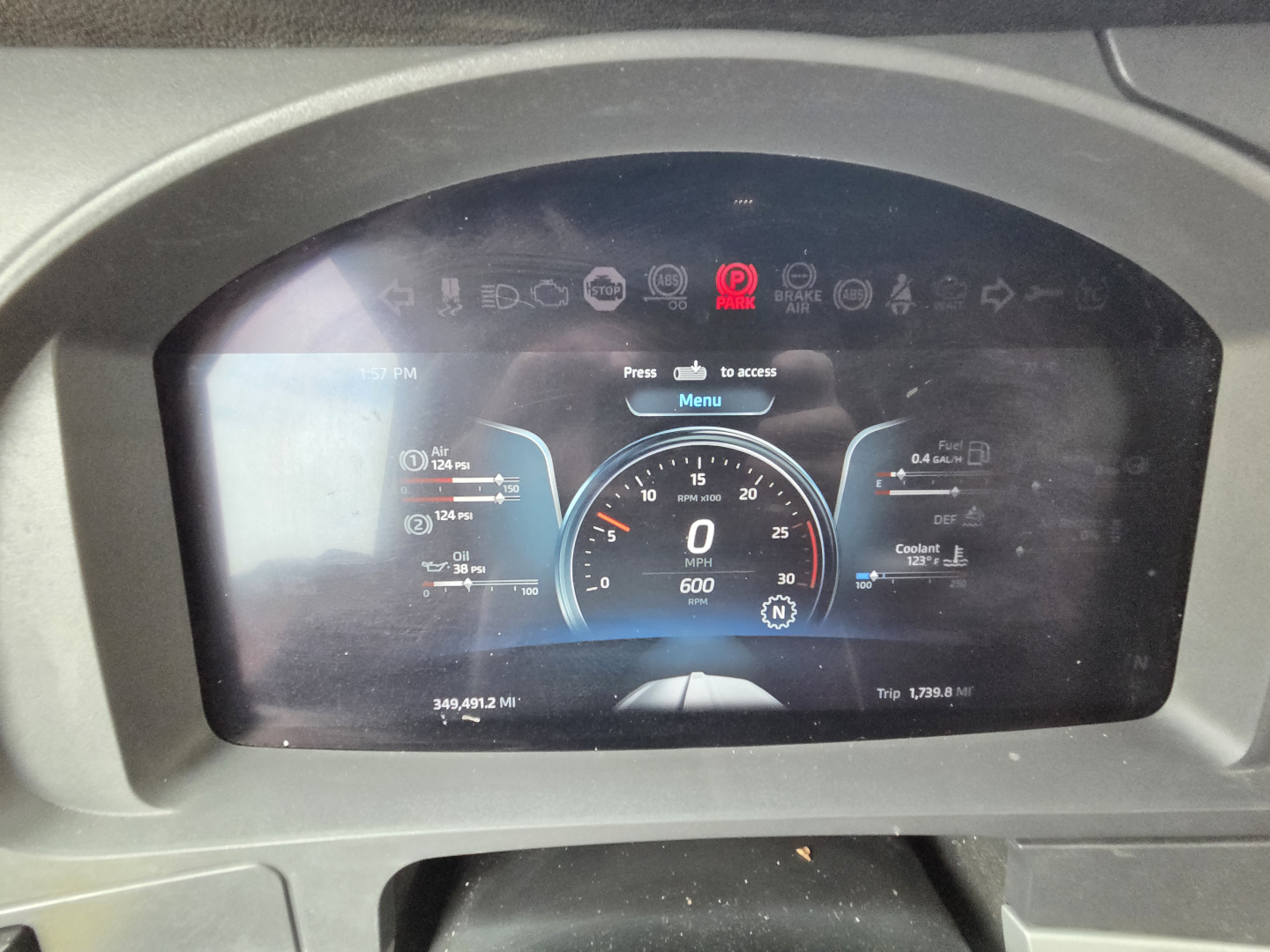 Kenworth T680 dash screen showing digital gauges and warning icons.