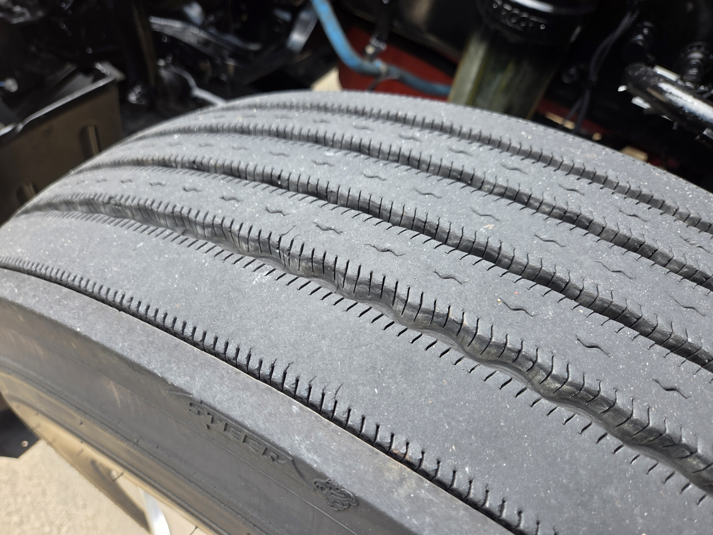 Kenworth T680 wheel tire close-up showing tread pattern and sidewall details.