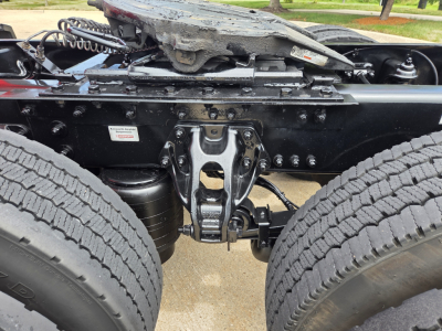 Truck chassis View showing fifth wheel hitch and dual rear wheels, Kenworth T680 undercarriage with suspension and drivetrain components.