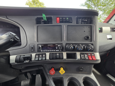 Kenworth T680 truck dashboard and center console showing controls and gauges from the cab interior.