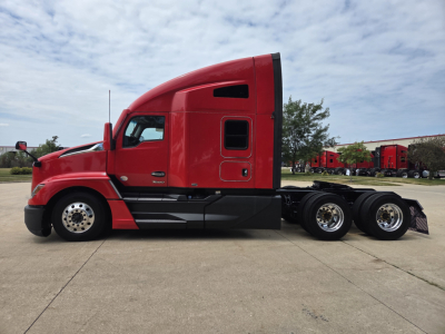 Kenworth T680 semi-truck side view showing red cab and black chassis with sleeper cab profile.