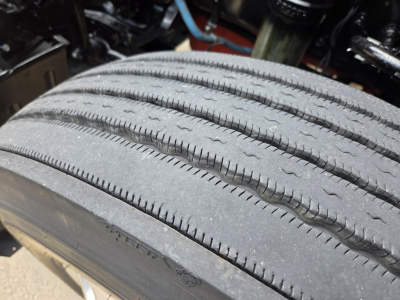 Kenworth T680 wheel tire close-up showing tread pattern and sidewall details.
