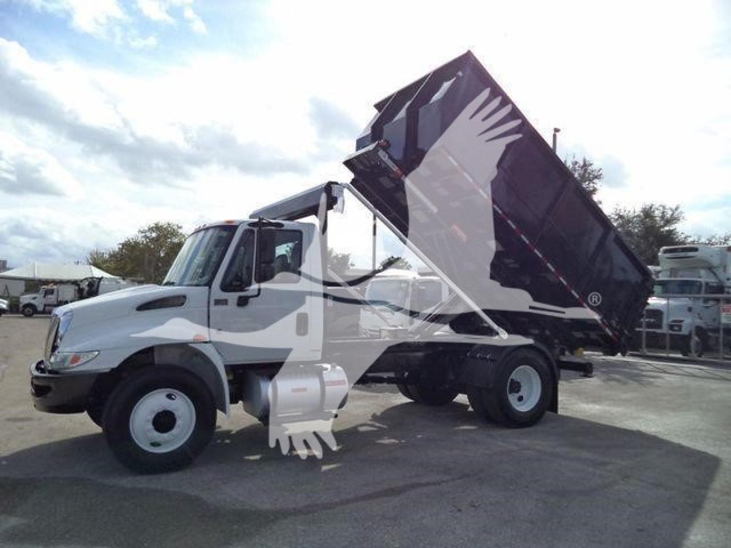Truck cab and raised dump bed on a 2019 International Durastar 4300 rolloff.