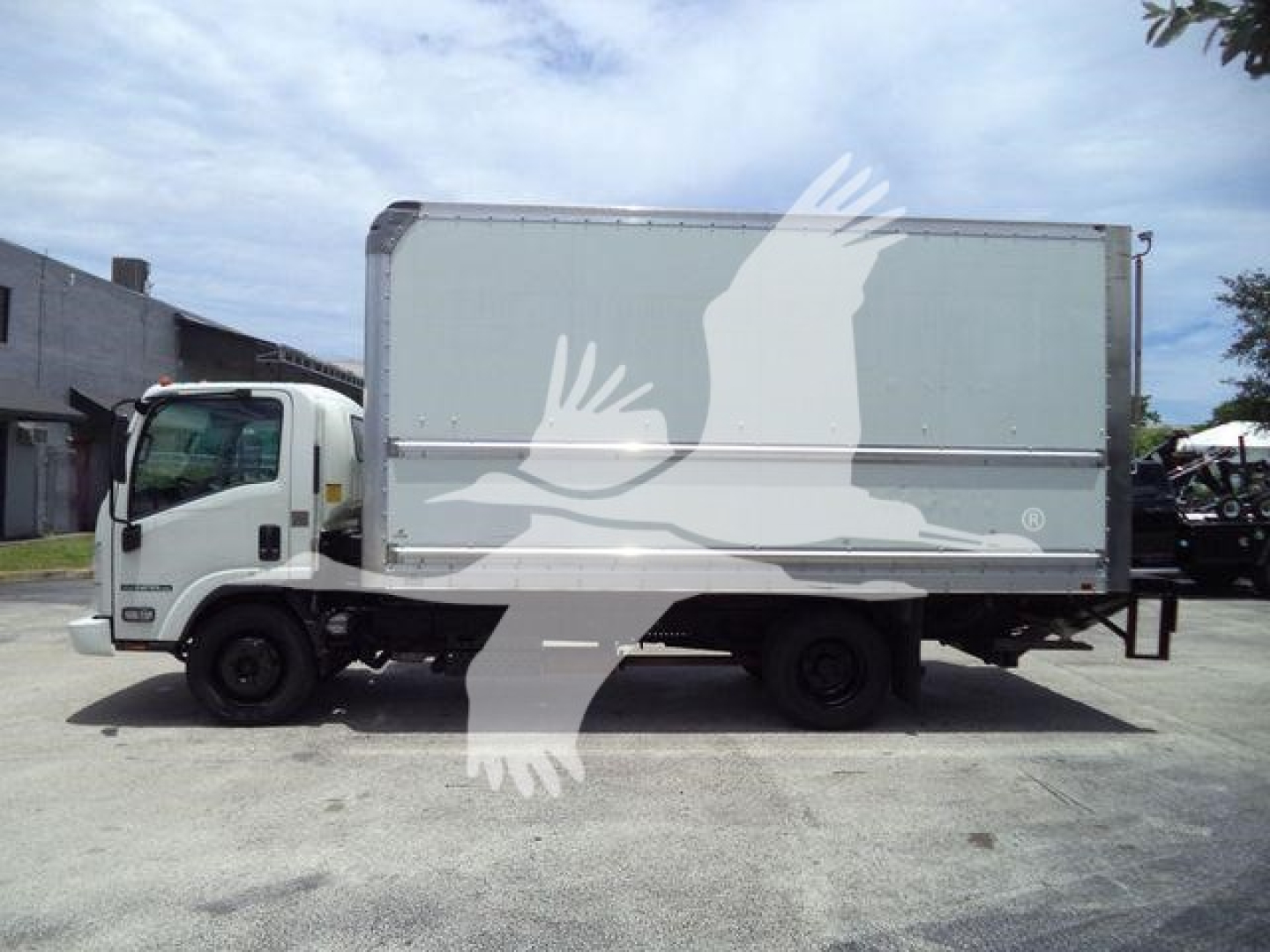 Isuzu NPR HD box truck side view with cab and cargo box, no visible text on body.
