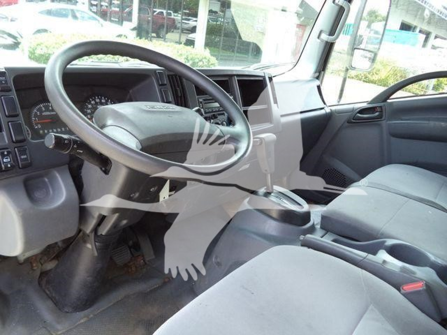 Isuzu NPR HD interior showing steering wheel and dashboard with gear shifter and driver seat