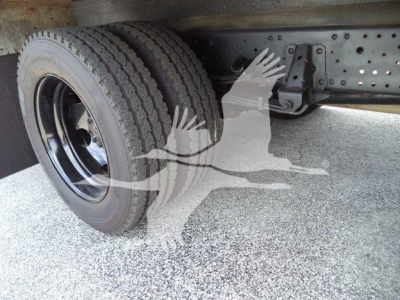 Isuzu NPR HD truck undercarriage showing dual rear wheels and chassis frame