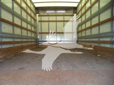 Isuzu NPR HD truck cargo area showing empty box with wooden side rails and metal floor panels.
