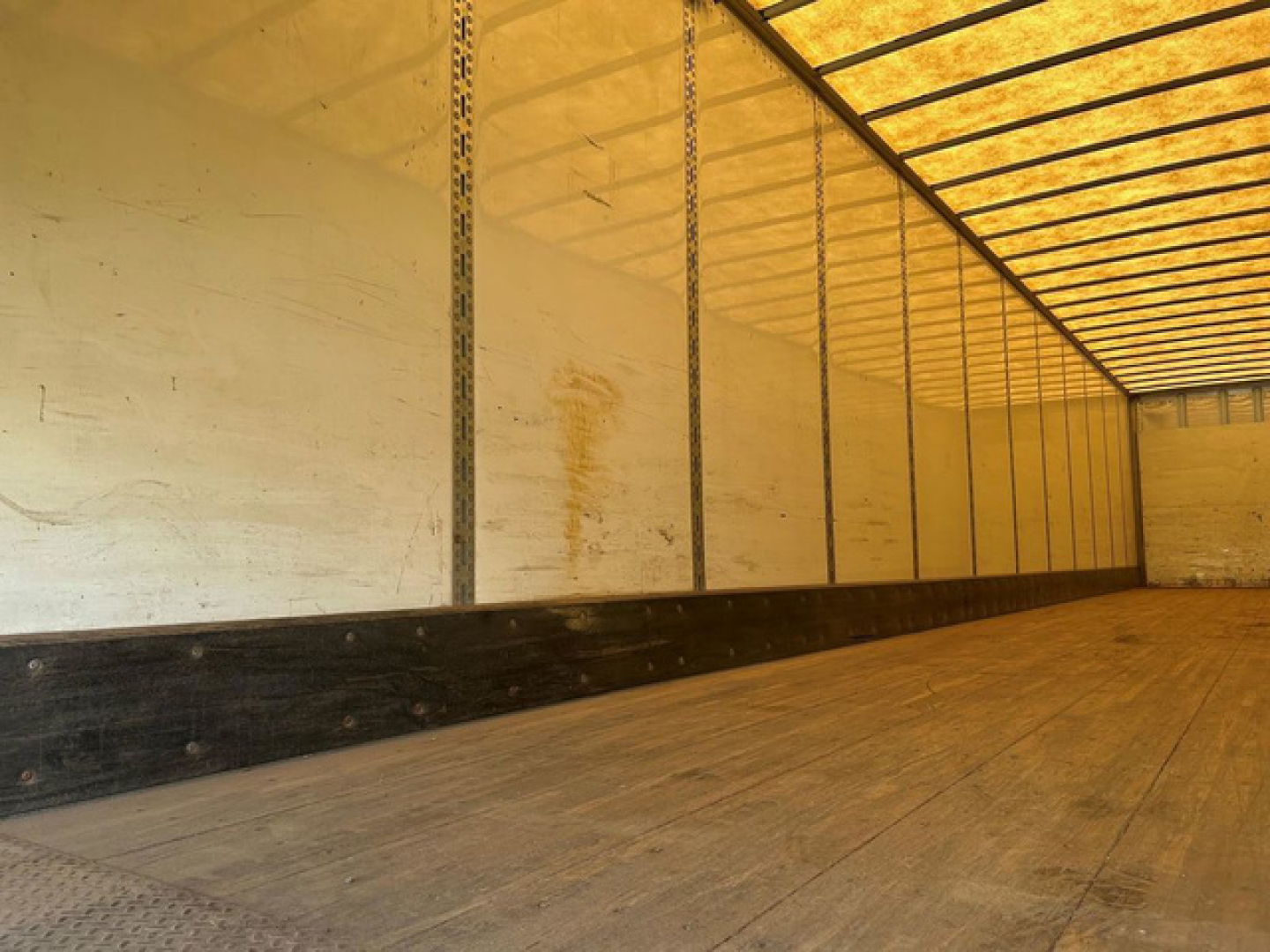 Interior of a 2016 Wabash van trailer showing empty cargo area with wooden floor and side walls.