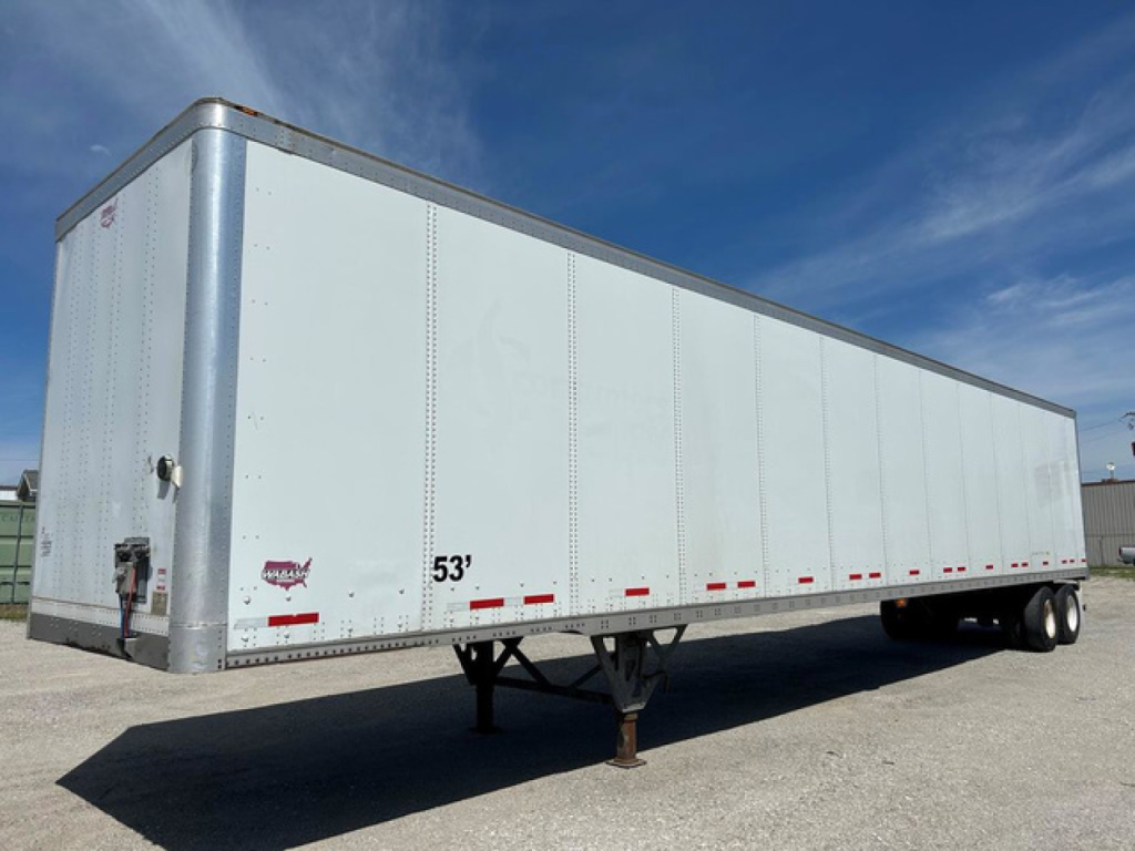 Trailer side view showing a large white 53' semi-trailer with wheels at the rear, support legs in front, and small red reflectors along the lower edge.
