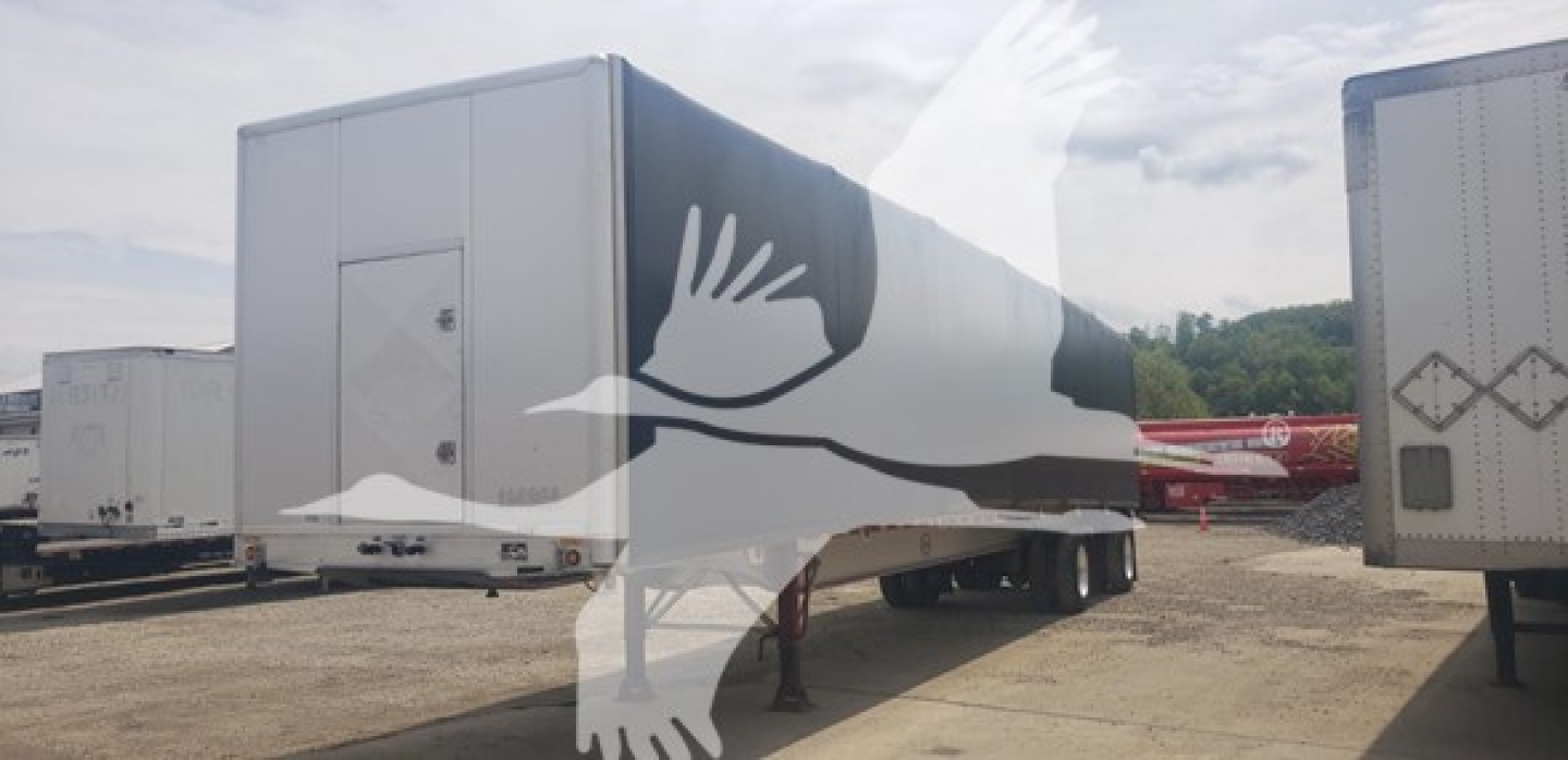 Curtainside trailer in view showing side profile and rear door, 2013 Mac Alum Flat - 72K Beam, aluminum flatbed trailer with side panel doors.