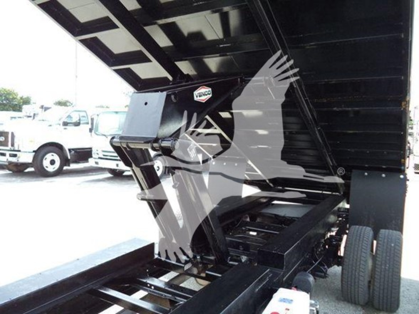 Dump truck bed with hydraulic tipping mechanism and rear dual wheels visible; Ford E450 2011 shown in img with VIN label obscured by watermark.