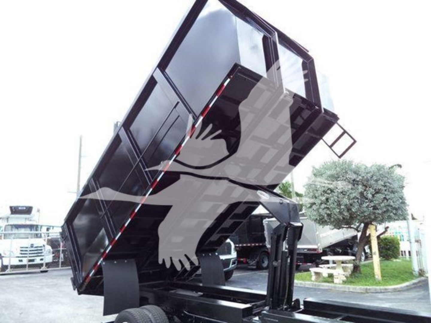 Truck dump bed raised on a 2011 Ford E450 showing the dump mechanism and side panels.
