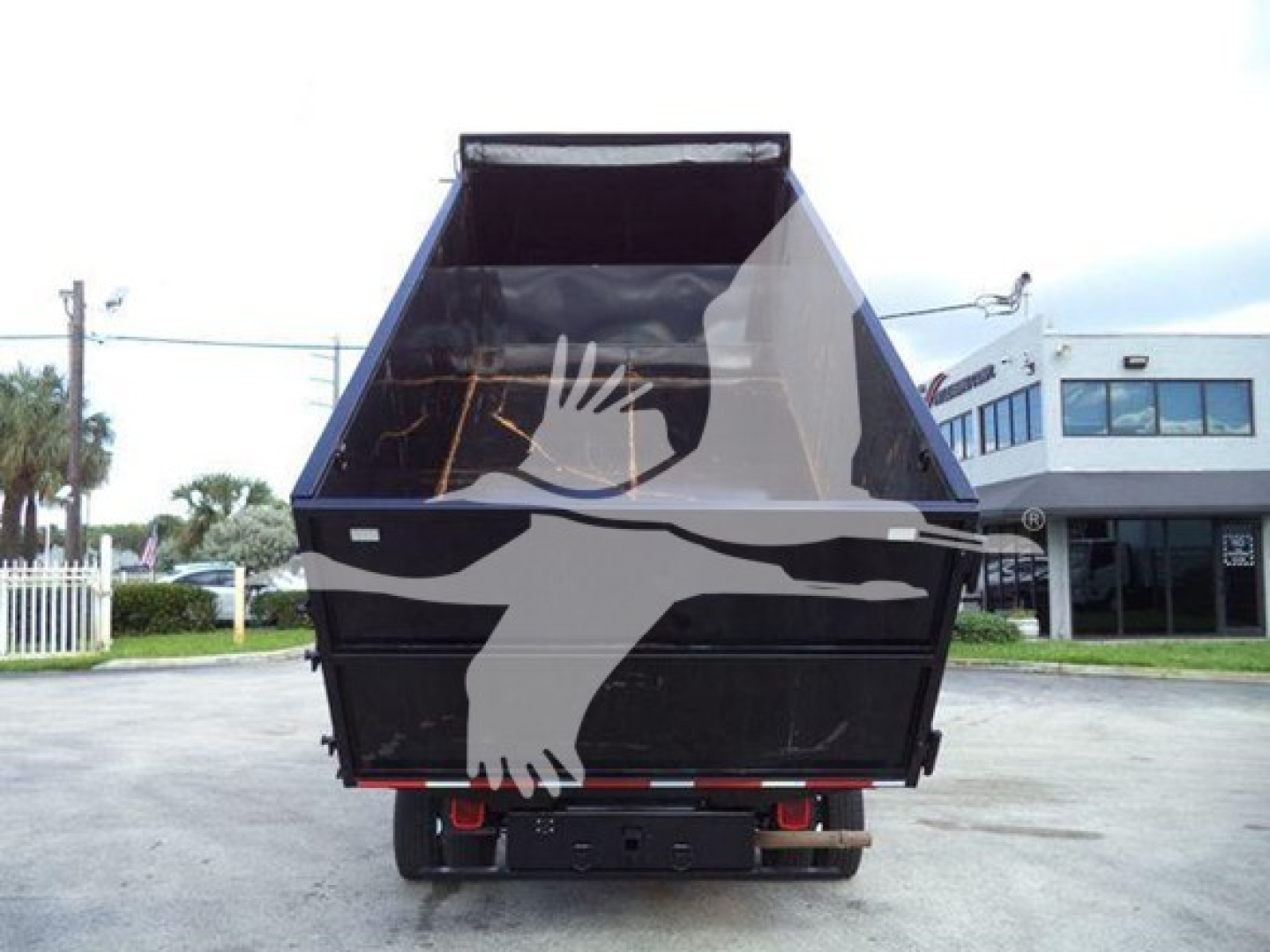 Dump truck bed of a Ford E-450 dump truck showing rear view with empty cargo bed and taillights.