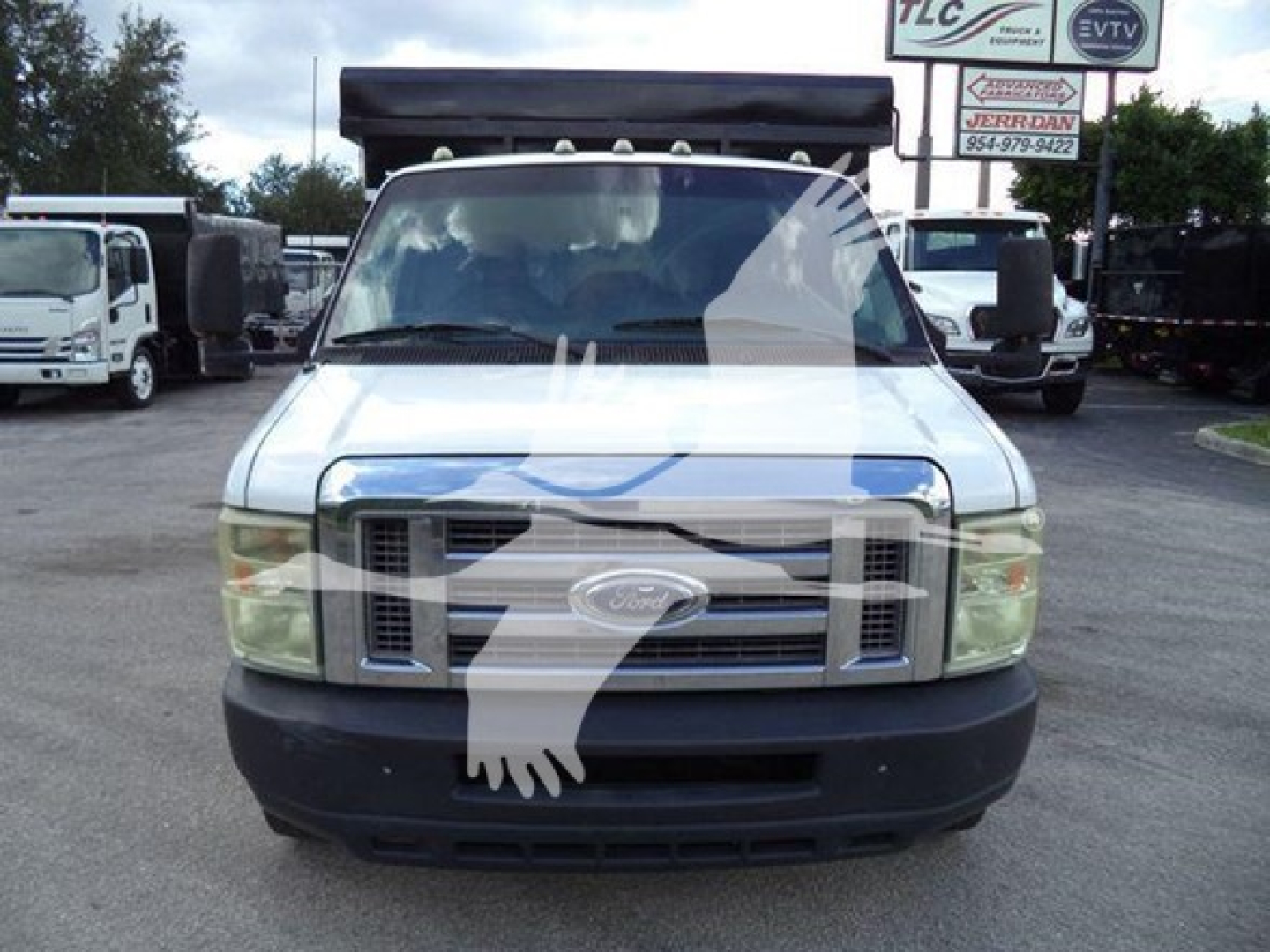 Ford E-450 utility truck front view showing grille and windshield with stock number T10516 label in background
