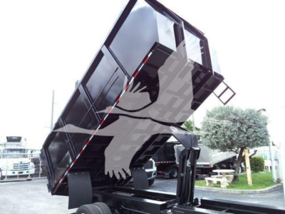 Truck dump bed raised on a 2011 Ford E450 showing the dump mechanism and side panels.