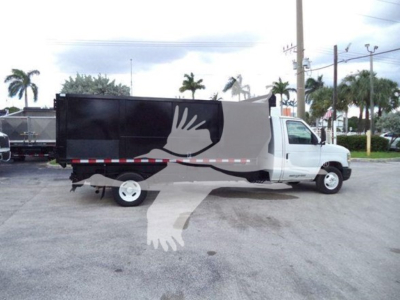 2011 Ford E450 dump truck side view showing black cargo box with white dove logo and red/white reflective stripe along the bottom edge.