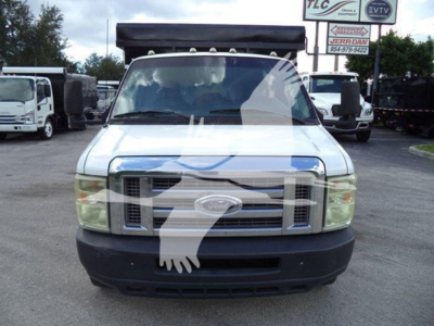 Ford E-450 utility truck front view showing grille and windshield with stock number T10516 label in background