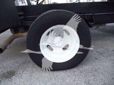 Front wheel and tire of a Ford E450 chassis showing wheel and suspension components.