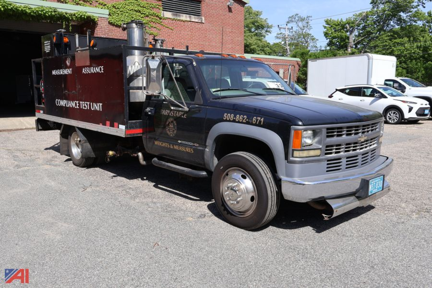 Service/utility truck showing VIN 3GBKC34F72M114260 and text on side panels, Chevrolet GMT-400 3500 1 Ton chassis cab with utility body.
