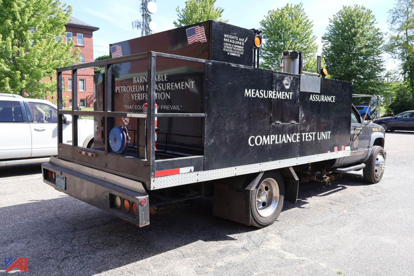 Service/utility truck bed with measurement/assurance compliance test unit on a flatbed truck