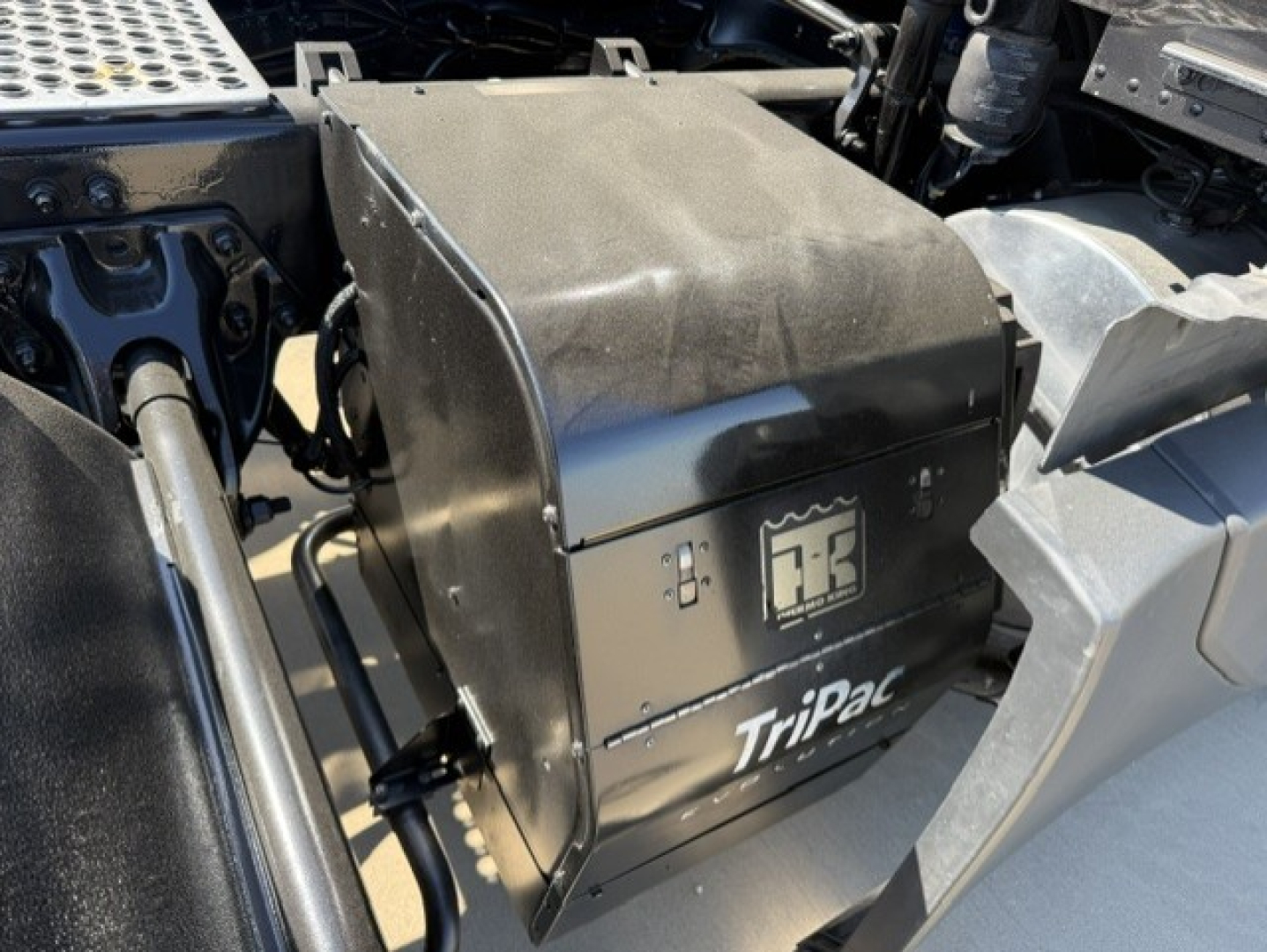 Truck fuel/auxiliary compartment labeled Tripac for Kenworth T680, side view with battery box and adjacent components visible.