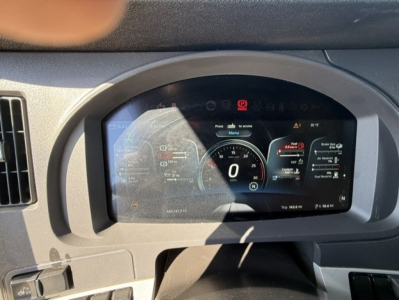 Kenworth T680 dashboard showing digital instrument cluster with speedometer at 0 and warning icons.