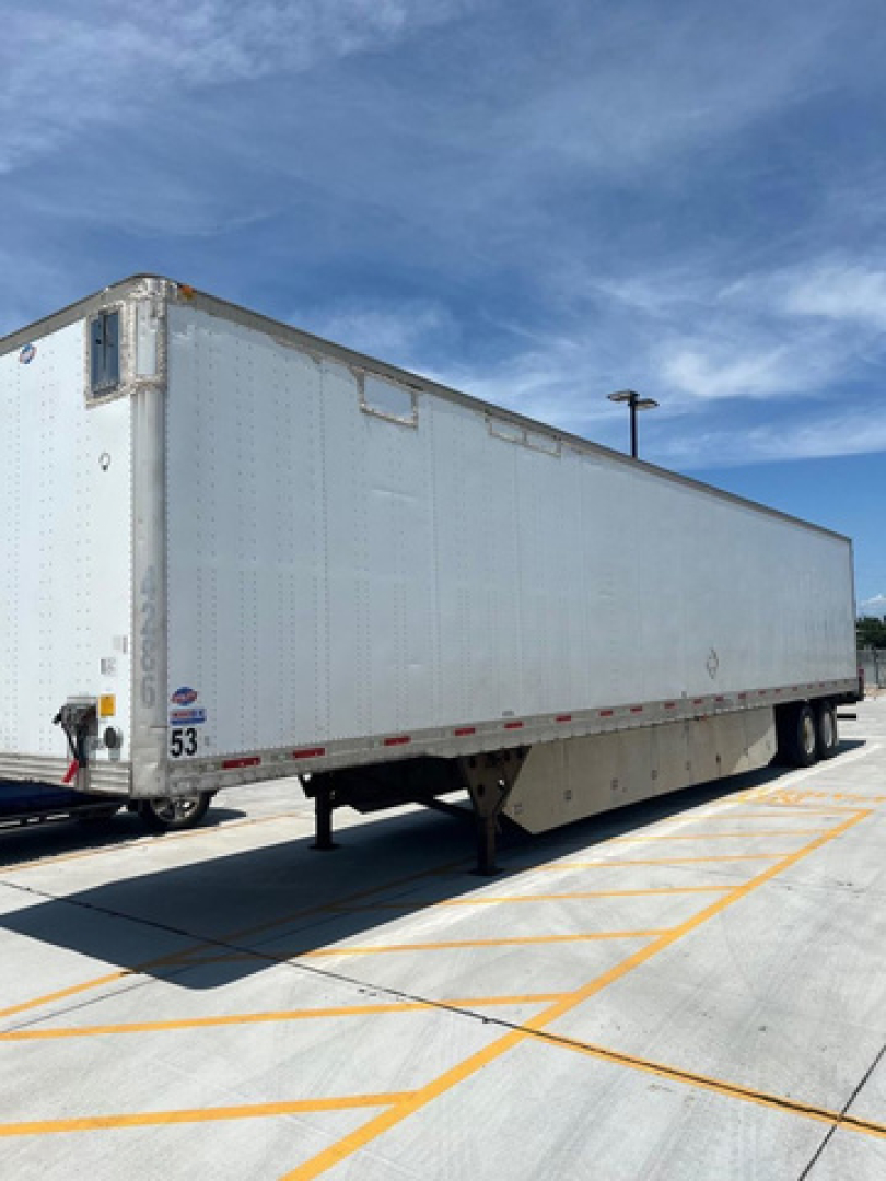 Used 2012 utility van trailer showing side and rear, with VIN 1UYVS2539CP189601 and stock number U90577 visible on the trailer.