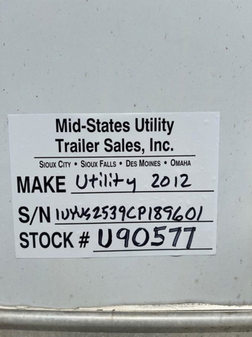 Plate on mid-states utility trailer showing Make Utility 2012, S/N 1UYVS2539CP189601, STOCK # U90577 from Mid-States Utility Trailer Sales, Inc.