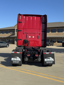 Rear view of a red 2018 International LT625 truck in a parking lot, showing the back of the cab, dual rear wheels, and mudflaps with KorDel logos.