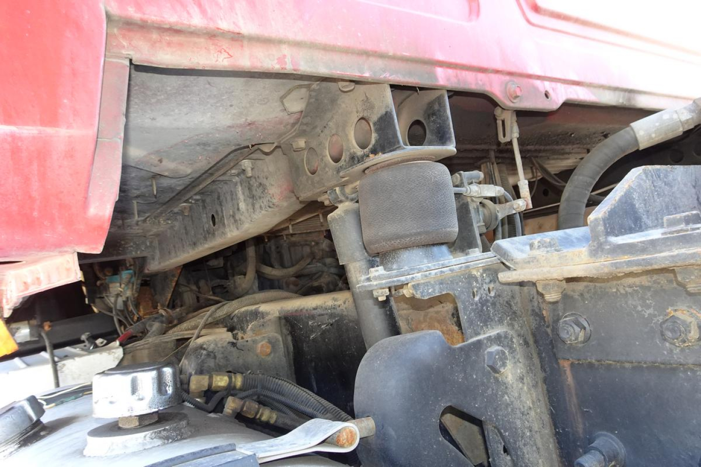 Truck engine bay view of a 2005 Mack CV Granite CV713 showing underhood components and hydraulic lines.